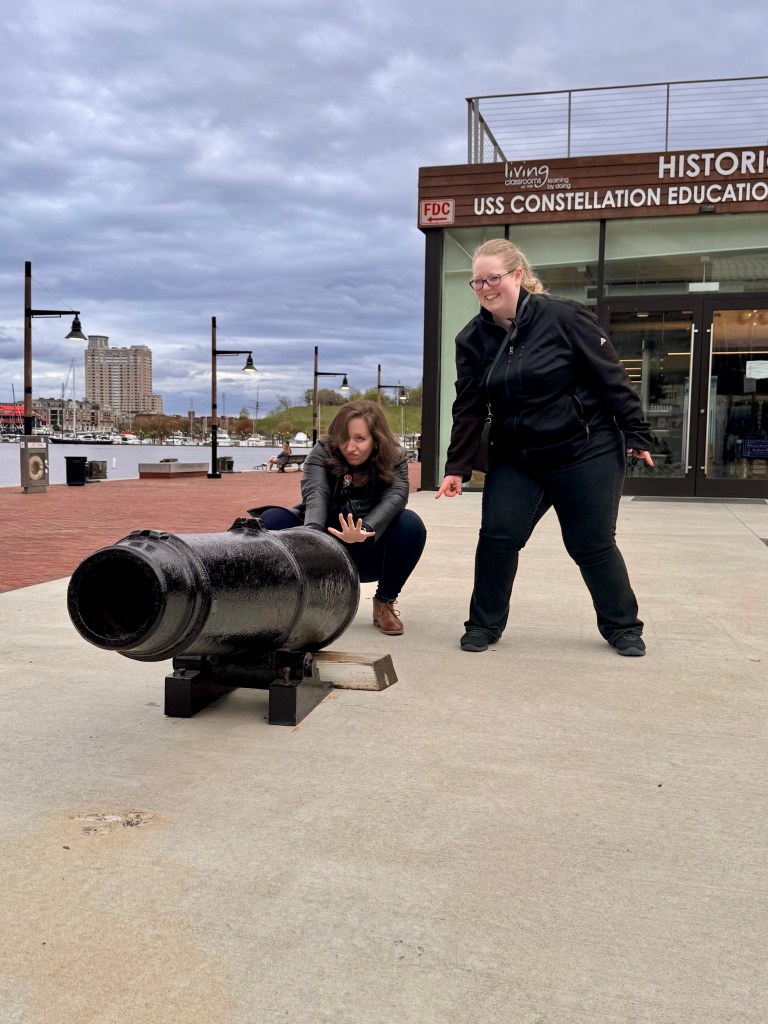 Marisa and frequent collaborator Kailyn pose in front of a cannon on the Baltimore harbor after presenting at 4Cs.